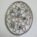 Blue topaz silver coat brooch
