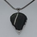 Green stone set in silver pendant