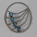 Silver blue topaz brooch
